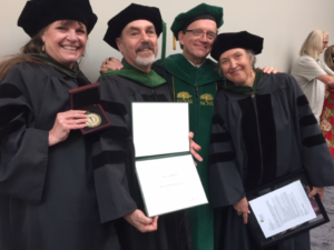 Winston (second from left) accepts his award.